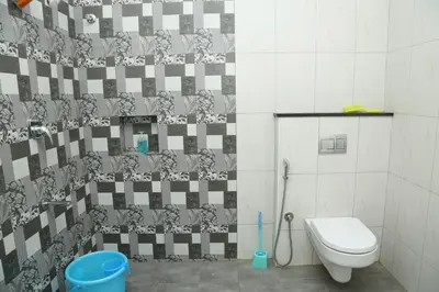 a bathroom with a toilet and a shower curtain at The best villa stay- family friendly in Coimbatore