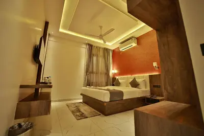 a hotel room with a bed and a window at The Mysore Grand in Mysore