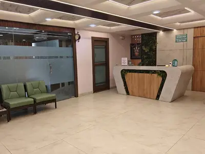 a lobby with two chairs and a reception desk at NavaRATNA Delight in Coimbatore