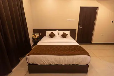 a bedroom with a large bed in a room at HOTEL PANKAJ RESIDENCY in Guruvāyūr