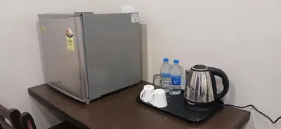 a counter with a refrigerator on top of a table at HOTEL PANKAJ RESIDENCY in Guruvāyūr