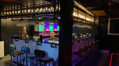 a bar with bar stools and wine glasses at The Zen Park Coimbatore in Coimbatore