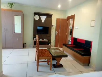 a living room with a couch and a table at Royal Plaza Residency in Cheruppulasseri