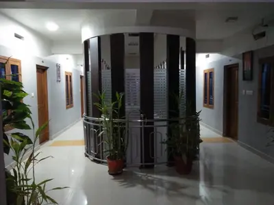 a hallway with potted plants in a building at MP RESIDANCY in Perintalmanna