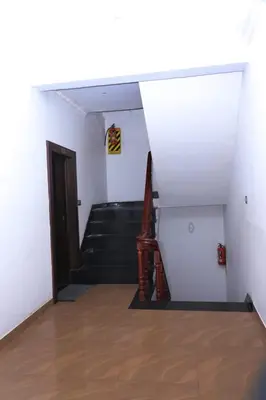 a hallway with a staircase and a stair case at Cloud Nine Kothagiri By Lexstays in Kotagiri