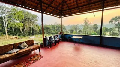 a living room with a couch and a table at Madan Homestay in Napoklu