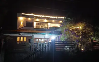 a house lit up at night with lights on it at Divine View Holyday Home (Homestay) in Kalpetta