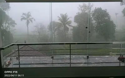 a view of a tennis court in the rain at Divine View Holyday Home (Homestay) in Kalpetta