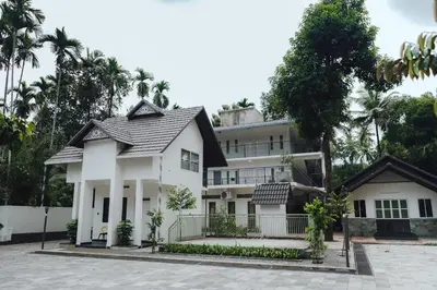 a house in the middle of a street at Royad Calicut Farm House - Premium Villa with Pool Inside a Farm in Kozhikode