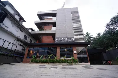 a building with a sign on the front of it at Lantern Apart Hotel in Perintalmanna