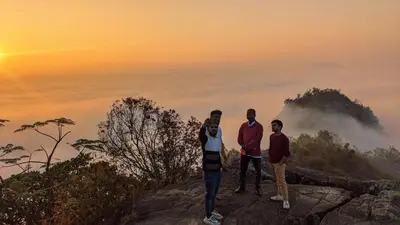 a group of people standing on top of a mountain at Crossroads Hostel 1957 in Wayanad