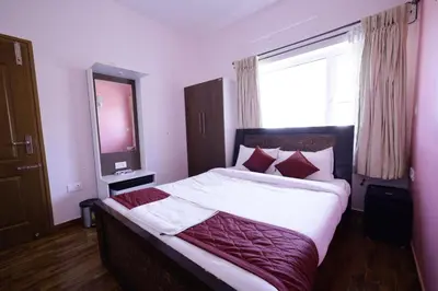 a bedroom with a large bed with a large window at PURPLE ORCHID BY XACRO XPERIENCES in Kodaikānāl