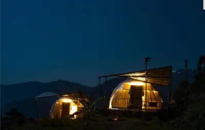 two domes with lights lit up at night at PURPLE ORCHID BY XACRO XPERIENCES in Kodaikānāl