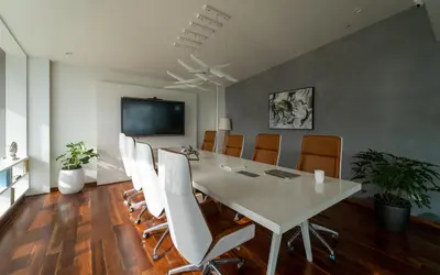 a conference room with a white table and chairs at Stays By MindEscapes in Ketti