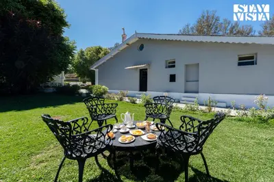 a table with chairs and food on it in a yard at StayVista at The Alcove with Breakfast & BBQ Grill in Ooty