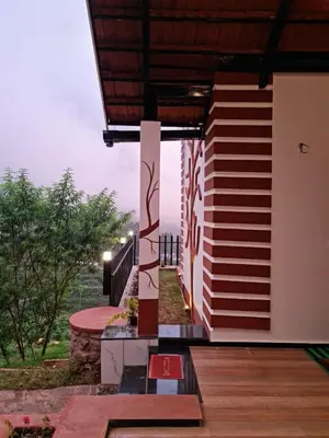 a view of a house with a balcony with a view at Sky Sketch in Kodaikānāl