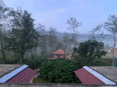 a view from the roof of a house with red tiles at FernHills Homestay in Madikeri