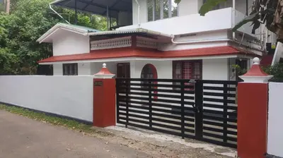 a house with a fence in front of it at 3 bedroom country home with a lush full backyard in Trichūr