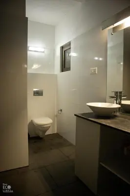 a bathroom with a sink and a toilet at Uravu Bamboo Grove Resort in Wayanad
