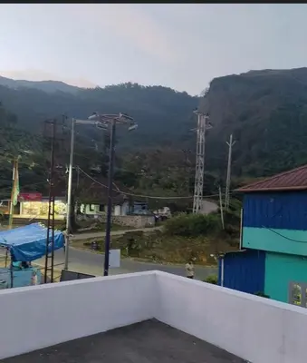 a view of a mountain from the roof of a building at 7coloursholidays in Kanthalloor