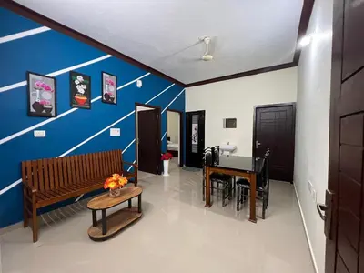 a living room with a bench and a table at Fathima Apartments in Iritti