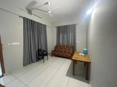 a living room with a couch and a table at HOLLYWOOD Rooms in Sultan Bathery
