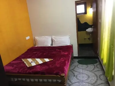 a bedroom with a bed with a napkin on it at Seven Endue Cottages in Ooty