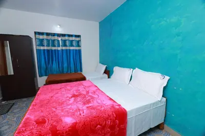 a bedroom with a bed and a blue wall at Seven Endue Cottages in Ooty
