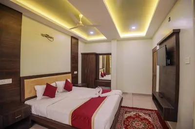 a bedroom with a large bed and a tv at zanbaq residency in Vythiri