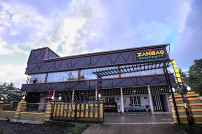 a building with a sign that reads karma restaurant at zanbaq residency in Vythiri
