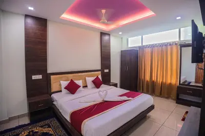 a bedroom with a large bed with red pillows at zanbaq residency in Vythiri