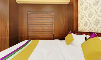 a bedroom with a bed and a wooden wall at Itsy Hotels Sapphire Residency in Manjeri