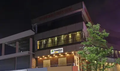 a building with a sign on the side of it at Itsy Hotels Sapphire Residency in Manjeri