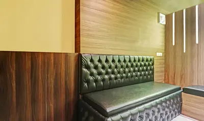 a leather seat in a booth in a room at Itsy Hotels Sapphire Residency in Manjeri
