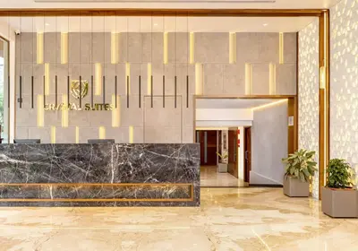 a lobby of a hotel with a marble counter at Crystal Suites in Badagara