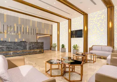 a lobby with couches and tables in a building at Crystal Suites in Badagara