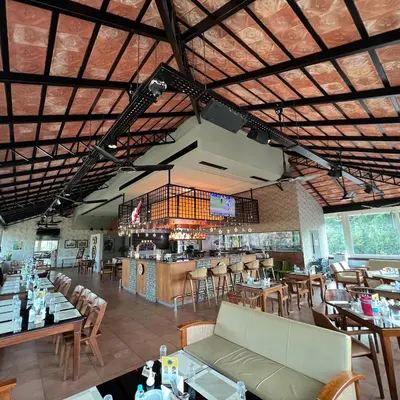 a restaurant with tables and chairs and a bar at PEARL MAHE in Mahe