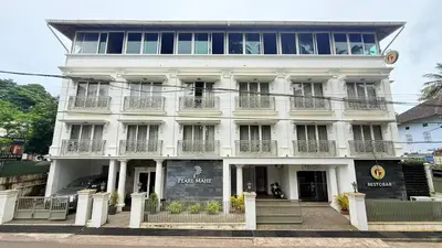 a large white building with windows and balconies at PEARL MAHE in Mahe