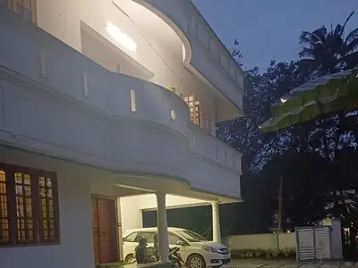 a car parked in the front of a building at Thas apartment near rajagiri hospital in Alwaye