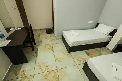 a small room with a bed and a desk at Aldora Airport Residency in Nedumbassery