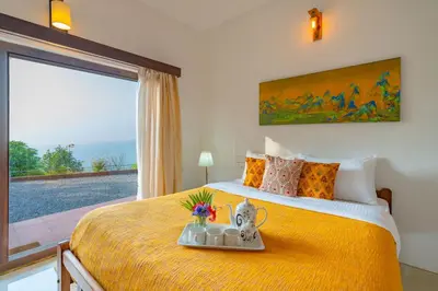 a bedroom with a large yellow bed with a tray on it at La Grove 2BHK with Stunning View - Kannur in Wayanad
