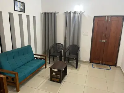a living room with a blue couch and chairs at HOLLYWOOD Villa in Sultan Bathery
