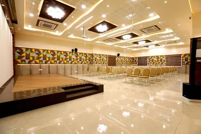 a conference room with chairs and tables in it at Chetinaad Courtyard Gandhipuram by Centre Park in Coimbatore