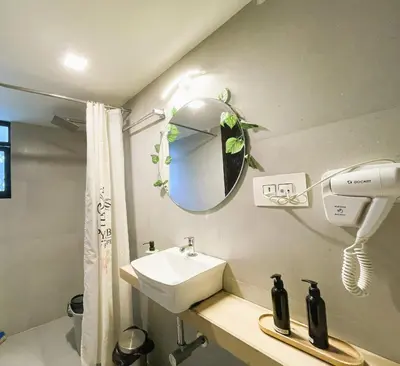 a bathroom with a sink and a mirror at The Little Acres Cherai in Vypīn