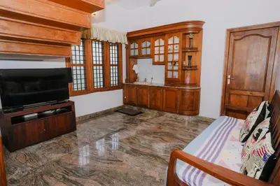 a living room with a tv and a couch at Alite Posh 4 BHK Villa in Thrissur Town in Trichūr