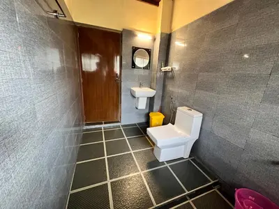 a bathroom with a toilet and a sink at Zyamadhari in Mananthavady