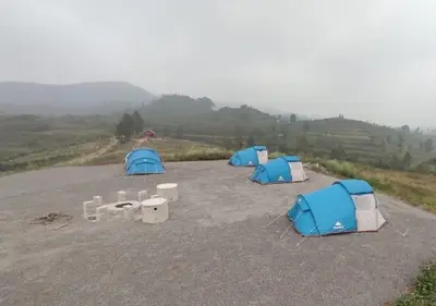 a group of three tents in a parking lot at Misty Valley Resort in Varagampadi