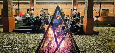 a crowd of people sitting on steps in a building at Misty Valley Resort in Varagampadi