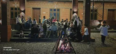 a group of people sitting on the steps of a building at Misty Valley Resort in Varagampadi