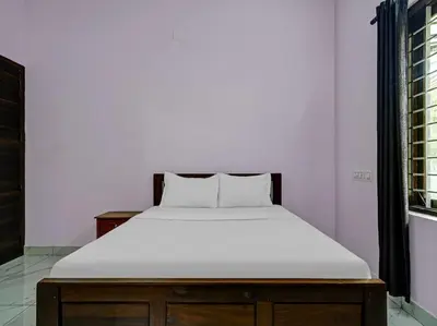 a bed with a white mattress in a room at Shalom Palace Residency in Neriyamangalam